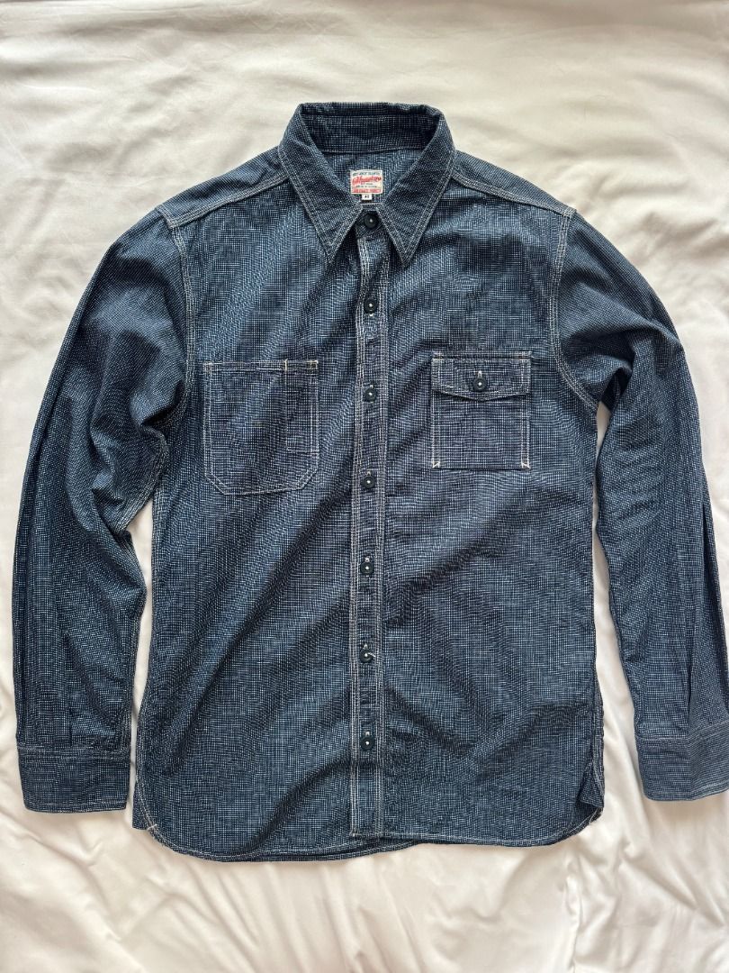 Momotaro Jeans Long sleeve button down shirt indigo patterned (Category: Formal Shirts) located in Cebu City. Submitted by _t.rix (Listing ID 1470366008, Image 1). Description: - Color: Indigo blue - Design: Subtle all-over textured pattern with structured collar - Pockets: Two front chest pockets with button flaps - Details: Dark buttons on center placket and sleeve cuffs - Hem: Standard shirt hem with clean stitching throughout Made in Japan.