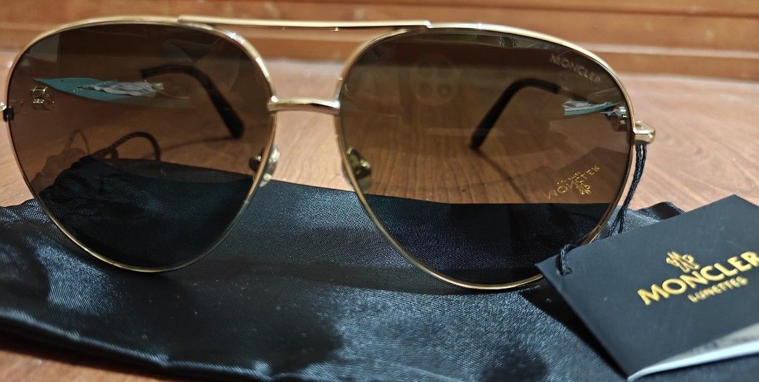 Moncler Polarized Sunglasses (Category: Sunglasses & Eyewear) located in Makati City. Submitted by tbstuff (Listing ID 1470373365, Image 1). Description: Moncler Lunettes - aviator sunglasses in shiny gold metal. Dark polarized gradient lenses. Model ML 0201 32R, size 60-12-145. Tortoise shell temple tips. Moncler logo detail on the side hinges. Includes original black pouch and brand tag. Never worn, tags still attached..