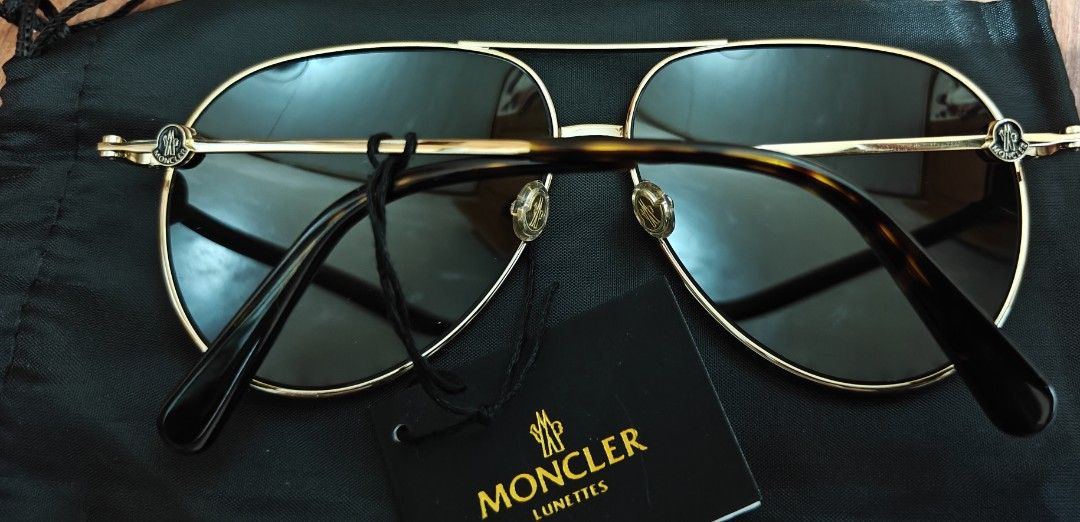 Moncler Polarized Sunglasses (Category: Sunglasses & Eyewear) located in Makati City. Submitted by tbstuff (Listing ID 1470373365, Image 3). Description: Moncler Lunettes - aviator sunglasses in shiny gold metal. Dark polarized gradient lenses. Model ML 0201 32R, size 60-12-145. Tortoise shell temple tips. Moncler logo detail on the side hinges. Includes original black pouch and brand tag. Never worn, tags still attached..