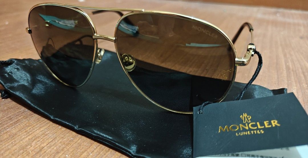 Moncler Polarized Sunglasses (Category: Sunglasses & Eyewear) located in Makati City. Submitted by tbstuff (Listing ID 1470373365, Image 2). Description: Moncler Lunettes - aviator sunglasses in shiny gold metal. Dark polarized gradient lenses. Model ML 0201 32R, size 60-12-145. Tortoise shell temple tips. Moncler logo detail on the side hinges. Includes original black pouch and brand tag. Never worn, tags still attached..