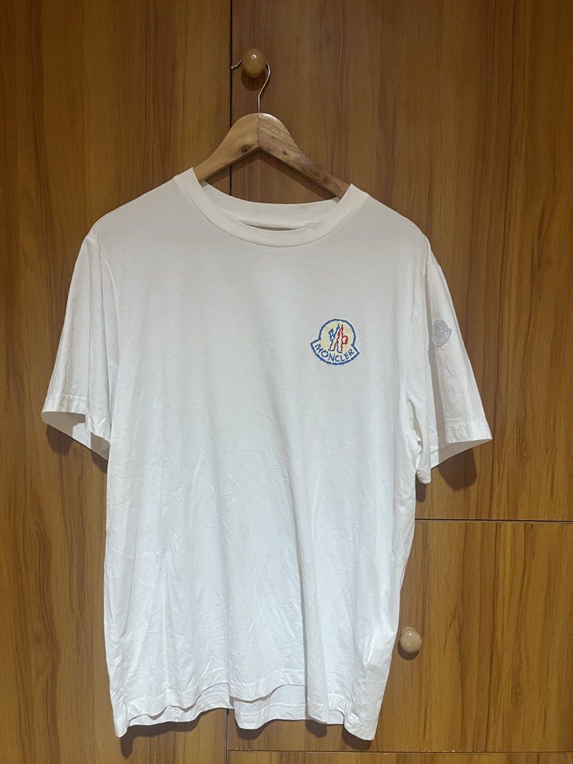 Moncler Pixel Logo White T-Shirt (Category: Tshirts & Polo Shirts ) located in Manila. Submitted by christian048 (Listing ID 1470388719, Image 2). Description: - Brand: Moncler - Color: White - Material: 100% Cotton - Origin: Made in Turkey - Design: Pixel logo on chest with small round sleeve patch - Fit: Regular fit, clean look - Condition: Brand new / excellent - Perfect for: Casual daily wear and designer streetwear - XL on tag Dimes: Width -