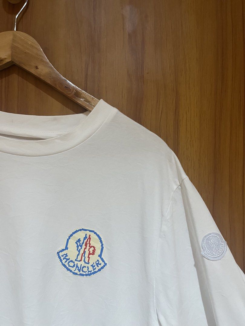 Moncler Pixel Logo White T-Shirt (Category: Tshirts & Polo Shirts ) located in Manila. Submitted by christian048 (Listing ID 1470388719, Image 3). Description: - Brand: Moncler - Color: White - Material: 100% Cotton - Origin: Made in Turkey - Design: Pixel logo on chest with small round sleeve patch - Fit: Regular fit, clean look - Condition: Brand new / excellent - Perfect for: Casual daily wear and designer streetwear - XL on tag Dimes: Width -