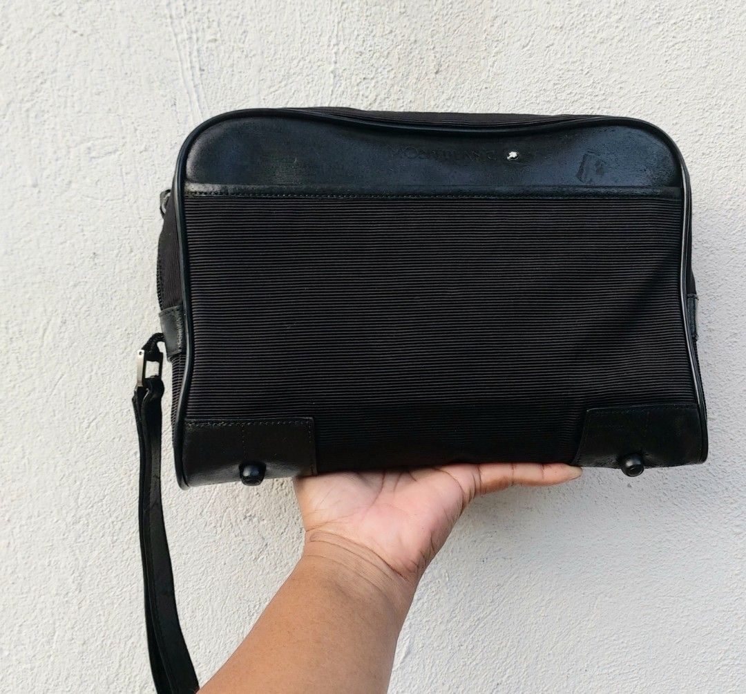 Montblanc Black Clutch Bag (Category: Luxury Bags & Wallets) located in Lapu Lapu. Submitted by agnesapm_29813 (Listing ID 1470488699, Image 1). Description: - Brand: Montblanc - Color: Classic Black - Material: Premium ribbed fabric with genuine leather trim - Portability: Convenient side wrist strap - Protection: Metal feet on the bottom base - Interior: Roomy main compartment for all grooming and travel essentials - Measurements: width-10.5 in