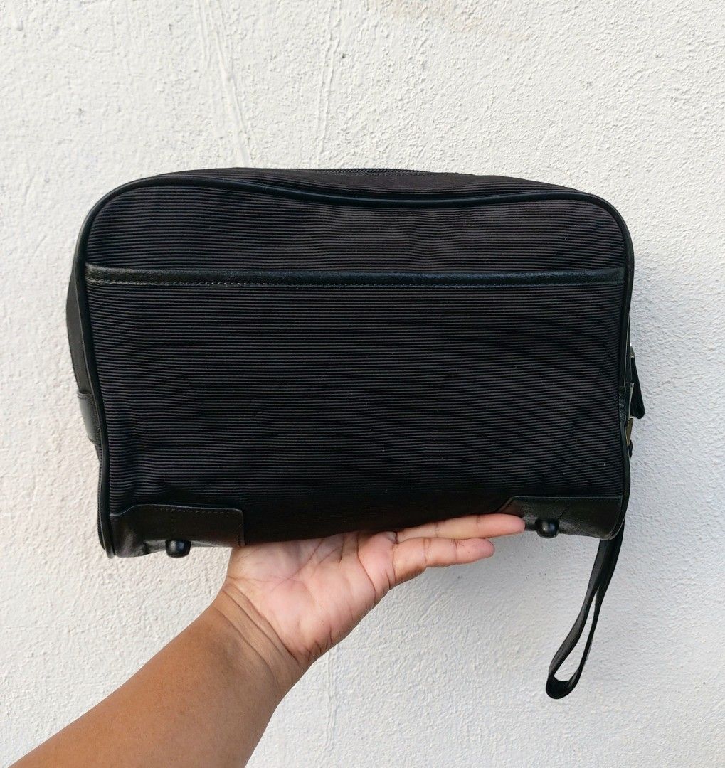Montblanc Black Clutch Bag (Category: Luxury Bags & Wallets) located in Lapu Lapu. Submitted by agnesapm_29813 (Listing ID 1470488699, Image 3). Description: - Brand: Montblanc - Color: Classic Black - Material: Premium ribbed fabric with genuine leather trim - Portability: Convenient side wrist strap - Protection: Metal feet on the bottom base - Interior: Roomy main compartment for all grooming and travel essentials - Measurements: width-10.5 in