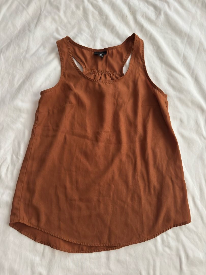 Mossimo Rust Orange Racerback Tank Top Size XS (Category: Sleeveless) located in Cebu City. Submitted by _t.rix (Listing ID 1470373708, Image 1). Description: - Brand: Mossimo - Size: XS - Color: Rust orange - Material: Lightweight, flowy fabric (Made in Indonesia) - Design: Racerback with gathered pleated neckline and curved hem - Condition: Great basic piece for layering or wearing solo.