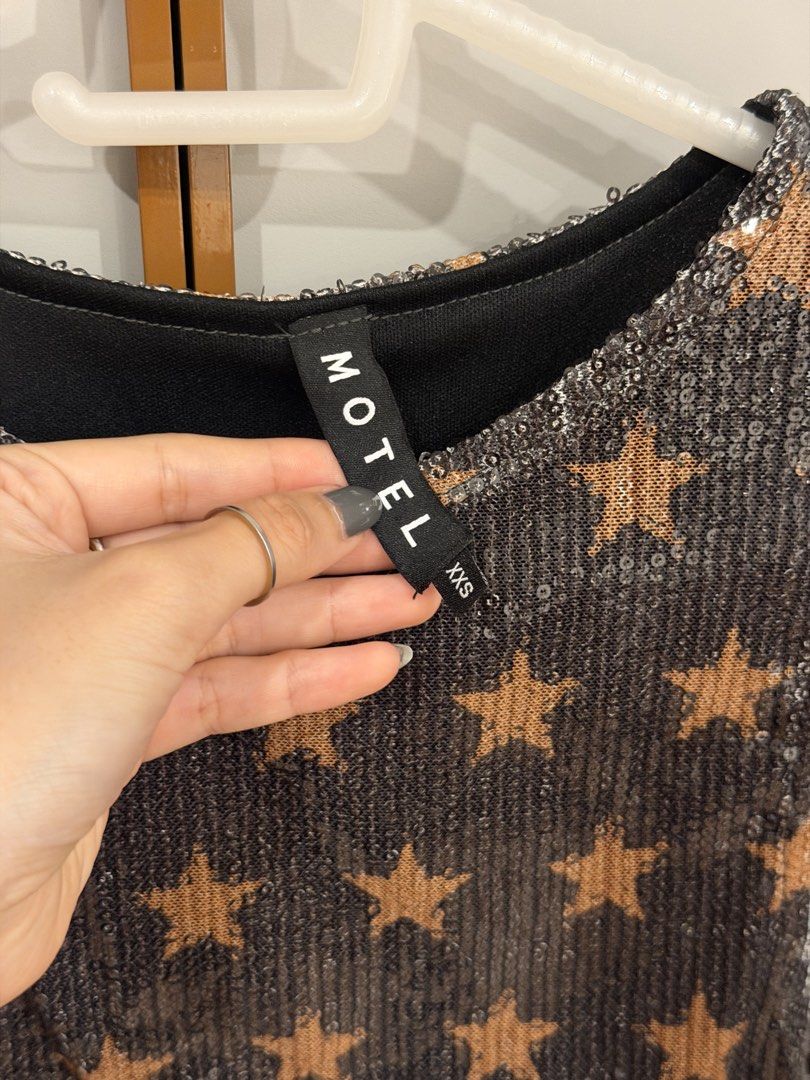 MOTEL ROCKS Sequin Star Print Sleeveless Top (Category: Sleeveless) located in Muntinlupa City. Submitted by closet.natalia (Listing ID 1470477907, Image 3). Description: MOTEL ROCKS Sequin Star Print Sleeveless Top ● Brand: MOTEL ● Size: XXS ● Color: Dark grey with brown stars ● All-over sequin detailing with star print ● Sleeveless with round neckline ● Fitted silhouette ● Fully lined 📌 Condition: Brand new, never been worn 📌 RFS: Not my styl