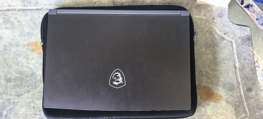 MSI Thin 15 Gaming Laptop Ryzen NVIDIA RTX (Category: Laptops & Notebooks) located in Abucay. Submitted by jerlynbal98316 (Listing ID 1470478264, Image 3). Description: - Brand/Model: MSI Gaming Laptop (Grey) - Processor: AMD Ryzen - Graphics: NVIDIA RTX - Display: Matte panel with MSI dragon logo wallpaper - Keyboard: Backlit with stylish cyan highlights on WASD keys - Condition: Kept clean, 100% working properly - Ideal For: Daily gaming sessio