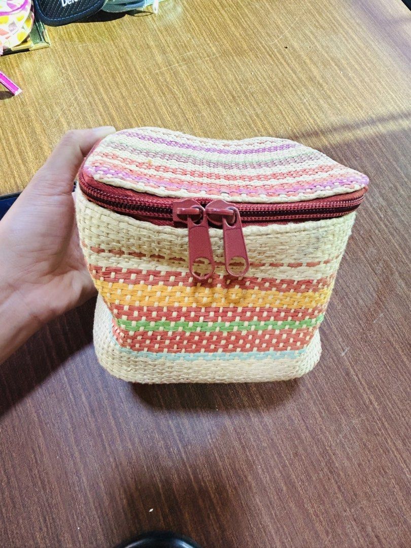 Multicolor Woven Makeup Pouch with Paisley Lining (Category: Purses & Pouches) located in Manila. Submitted by starbalesukandjapansurplus (Listing ID 1470555615, Image 1). Description: Handheld vanity pouch with colorful woven straw exterior. Striped pattern in yellow, red, green, and pink tones. Deep red dual zippers with matching pulls. Inside lined with brown fabric featuring a vibrant paisley and floral print. Tag attached inside. Structured 
