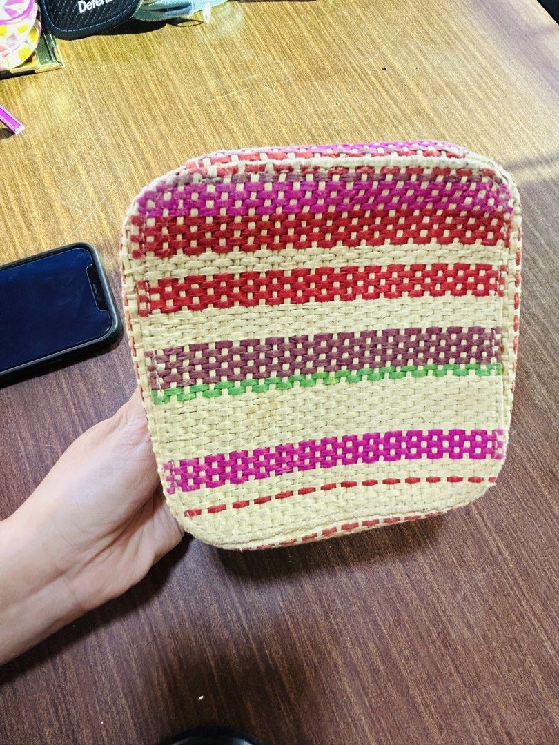 Multicolor Woven Makeup Pouch with Paisley Lining (Category: Purses & Pouches) located in Manila. Submitted by starbalesukandjapansurplus (Listing ID 1470555615, Image 3). Description: Handheld vanity pouch with colorful woven straw exterior. Striped pattern in yellow, red, green, and pink tones. Deep red dual zippers with matching pulls. Inside lined with brown fabric featuring a vibrant paisley and floral print. Tag attached inside. Structured 