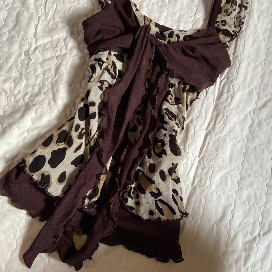 Nai-Fi Leopard Print Ruffle Tanking Top (Category: Sleeveless) located in Libungan. Submitted by whimsyypetal (Listing ID 1470550449, Image 2). Description: - Brand: Nai-Fi - Size: Medium (Tag attached) - Print: Brown leopard animal print with subtle metallic gold sparkle threads - Design: Scoop neckline, front tie bow detail, ruffled straps and hem - Material: Lightweight mesh - Condition: Brand new with tags.