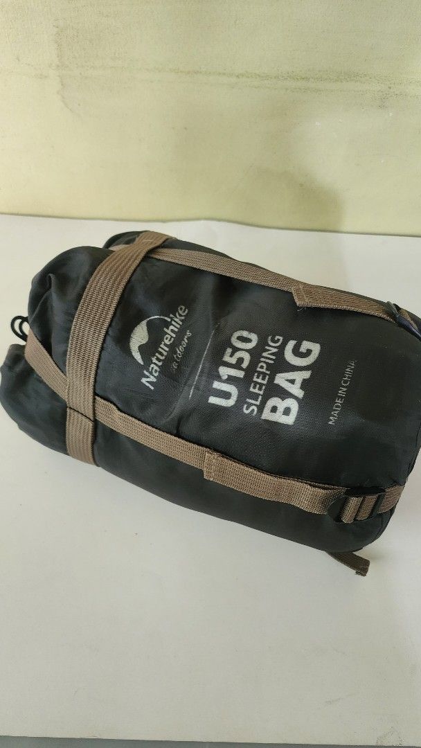 Naturehike U150 Sleeping Bag NH20MSD07 (Category: Hiking & Camping) located in Quezon City. Submitted by amenohana (Listing ID 1470356166, Image 3). Description: - Brand: Naturehike - Model: NH20MSD07 - Color: Black with stylish brown straps - Insulation: 150g/m² cotton hollow fiber for cozy warmth - Dimensions: 190cm x 75cm (fits adults up to 190cm) - Design: Compact and lightweight, ideal for camping and outdoor adventures - Storage: Includes a