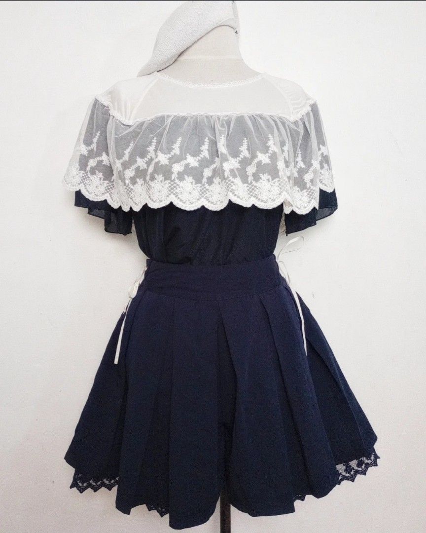 Navy Blue Axes Femme Coord Set (Category: Sets or Coordinates) located in Balanga. Submitted by marae_c (Listing ID 1470553875, Image 1). Description: Both axes femme In very good condition. Classic style navy blue coords. Lace overlay design sa top. Pa scallop layer yung bodice with flowy sleeves. Top and skorts. Has inner ling. Skorts has lace up design sa sides with 2 side pockets. Simple yet cute 🥰🤍 Fits S-M frames * edit. Measurements. Top