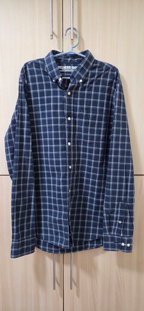 Navy Blue Long Sleeve Button-Up Shirt (Category: Tshirts & Polo Shirts ) located in Manila. Submitted by marco10e (Listing ID 1470407645, Image 1). Description: - Color: Dark navy blue with white plaid check pattern - Design: Long sleeves, button-up front, classic collar, and one chest pocket - Fit: Standard casual fit.