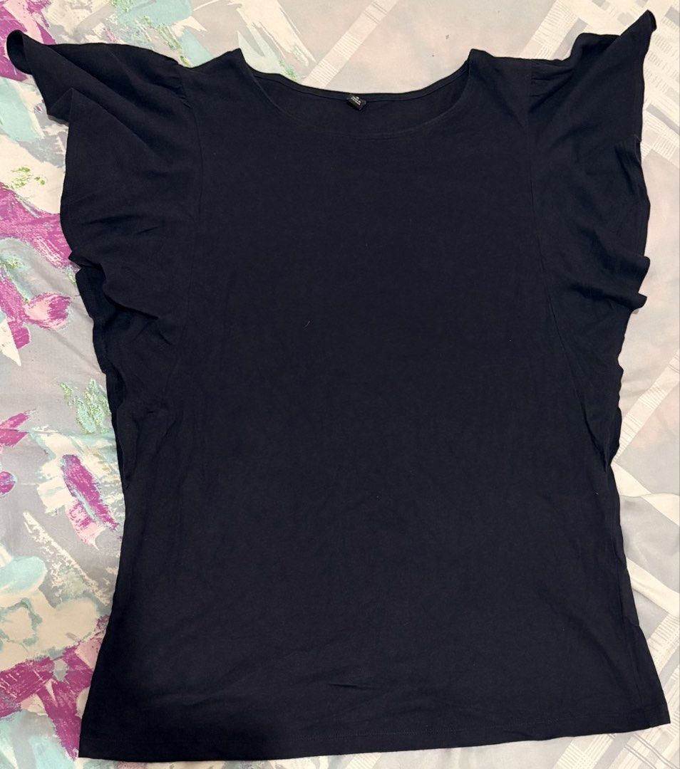 Navy Blue Ruffle Sleeve Top (Category: Blouses) located in Manila. Submitted by areiei (Listing ID 1470366743, Image 2). Description: - Brand: Uniqlo - Size: M on Tag - Design: Elegant layered ruffles on shoulders with a flattering scoop neckline - Material: Ultra-soft, breathable cotton fabric for all-day comfort - Versatility: Easy to dress up or down, perfect for pairing with jeans or skirts - Condition: Brand new and ready to wear.