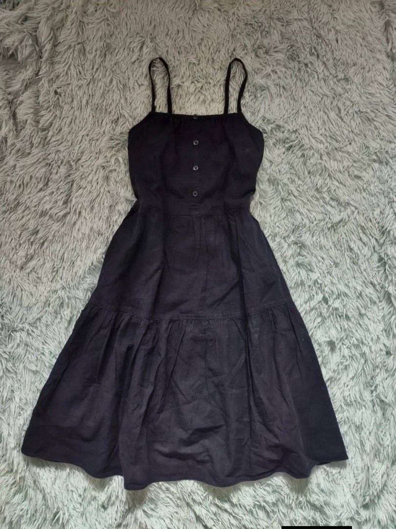 Navy Blue Spaghetti Strap Tiered Midi Dress (Category: Dresses) located in Quezon City. Submitted by alluring.avenue (Listing ID 1470549287, Image 1). Description: - Color: NAVY BLUE - Style: dress with flowy tiered skirt - Details: Thin spaghetti straps and front button bodice - Fabric: Lightweight and breathable - Perfect for: Casual days, warm weather, and easy styling with sandals or sneakers.