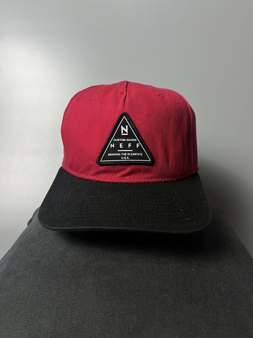 Neff Custom Goods Snapback Cap Red Black (Category: Caps & Hats) located in Dagupan City. Submitted by loves2thrifth (Listing ID 1470367863, Image 1). Description: - Brand: Neff - Colorway: Red and black - Design: Triangle patch with Neff logo and 'Braving the elements' text - Closure: Adjustable plastic snapback with small brand tag - Details: Branded interior seam taping, 100% cotton tag - Condition: Clean shape, brim holds its curve well.