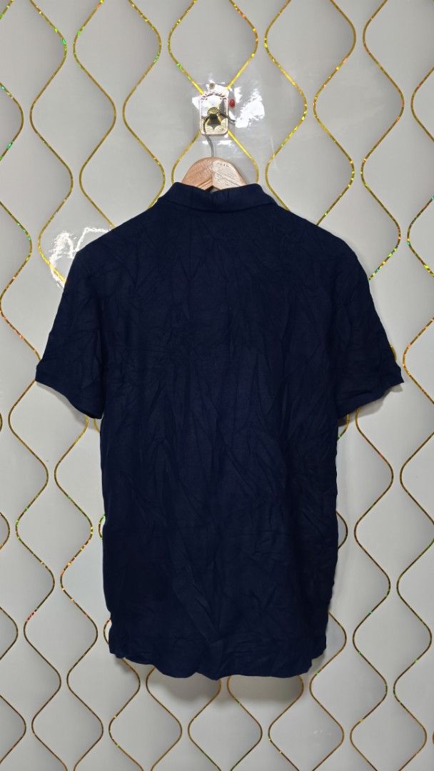NET Taiwan Blue Polo Shirt (Category: Tshirts & Polo Shirts ) located in Manila. Submitted by zariyah.1986 (Listing ID 1470448505, Image 3). Description: - Brand: NET Taiwan - Color: Navy blue with contrasting white and blue chest stripes - Size: L(21 Inches27 length) - Details: Embroidered crest emblem on left chest, button placket collar - Material: Cotton and polyester blend - Origin: Made in Vietnam.