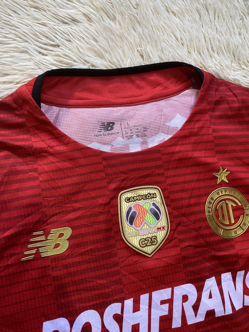 New Balance Toluca Home Jersey (Category: Activewear) located in Manila. Submitted by switchcity (Listing ID 1470409795, Image 2). Description: - Team: Deportivo Toluca (Home Jersey) - Brand: New Balance - Player Print: A. Vega #9 on the back - Size: Large - Condition/Material: 100% recycled polyester, red with subtle horizontal stripes - Features: Official Liga BBVA MX Campeón patch and sponsor logos (Roshfrans, Corona, Caliente).