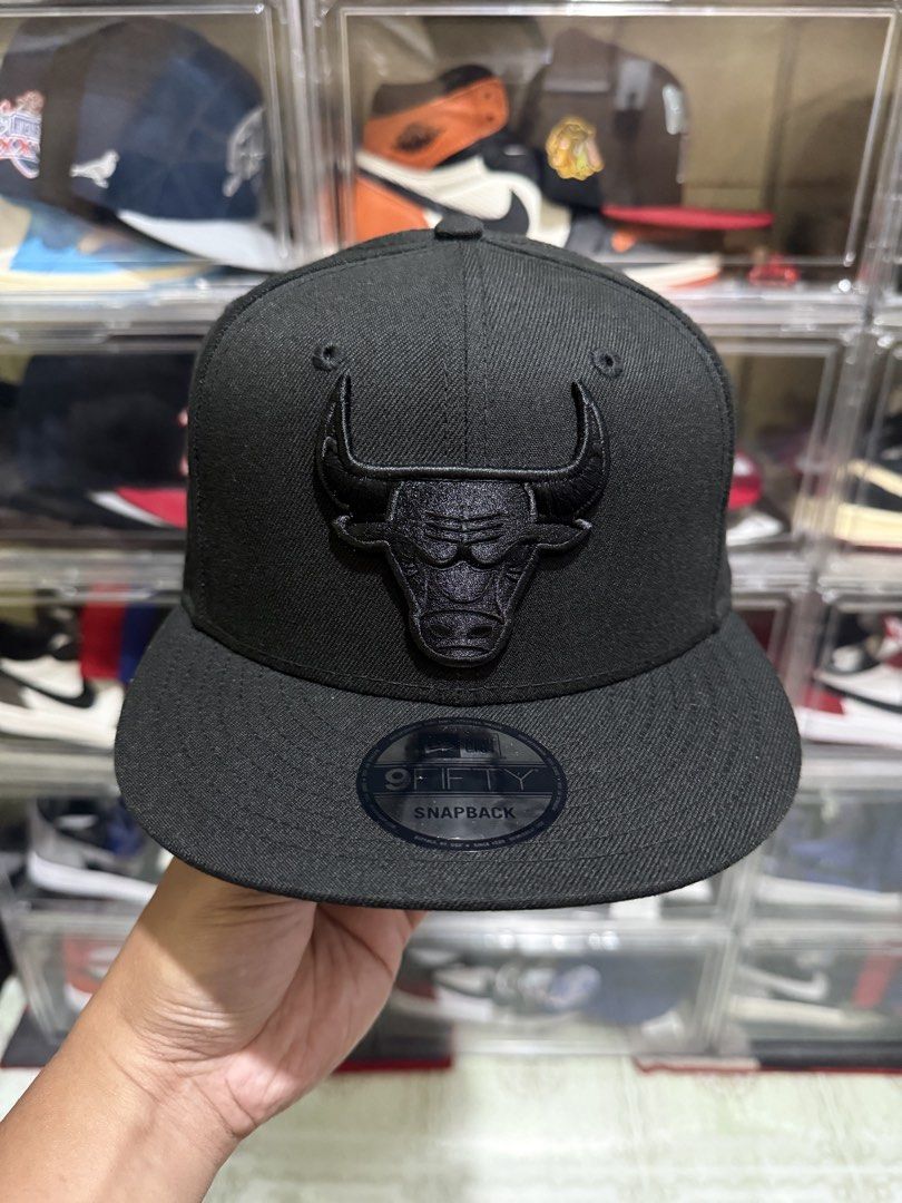 New Era 9Fifty Chicago Bulls Black Snapback Hat (Category: Caps & Hats) located in Manila. Submitted by batoy8814895 (Listing ID 1470433352, Image 1). Description: - Brand: New Era 9Fifty - Team: Chicago Bulls (All-Black tonal embroidery) - Condition: Clean structure, original size sticker still attached on brim - Closure: Adjustable snapback - Style: Versatile monochrome colorway that matches any outfit.