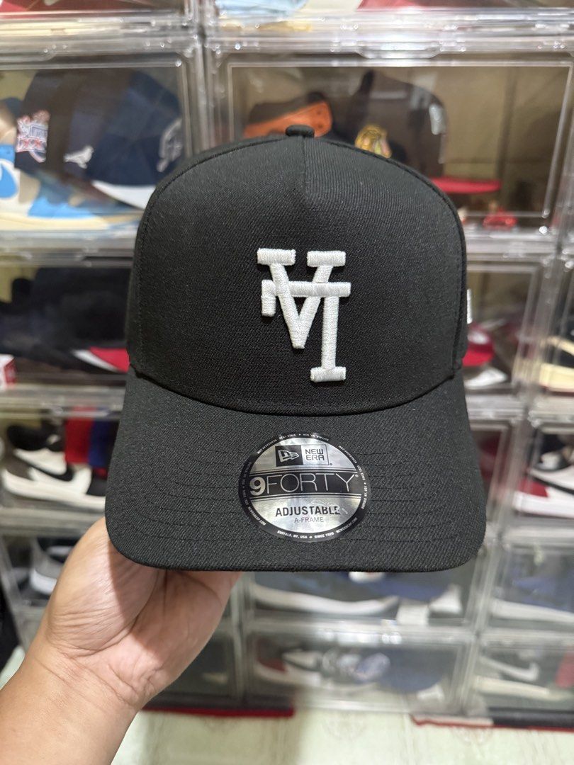 New Era 9Forty A-Frame Black LA Dodgers Cap (Category: Caps & Hats) located in Manila. Submitted by batoy8814895 (Listing ID 1470434364, Image 1). Description: - Brand: New Era 9Forty A-Frame - Color: Black with white embroidered LA Dodgers overlapping logo - Closure: Adjustable snapback - Details: Includes original silver foil brim sticker and clean stitching throughout - Condition: Brand new, stored securely in a clear display case.