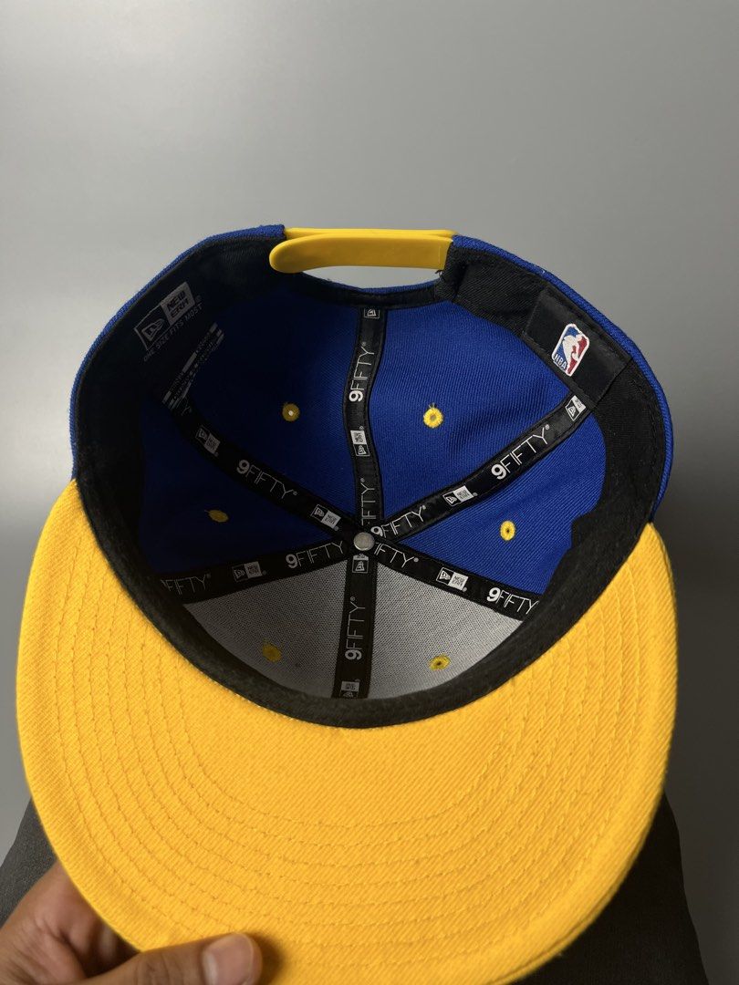 New Era Golden State Warriors 9FIFTY Snapback Cap (Category: Caps & Hats) located in Dagupan City. Submitted by loves2thrifth (Listing ID 1470368073, Image 3). Description: - Brand: New Era (Official NBA Merchandise) - Style: 9FIFTY Snapback Cap - Color: Royal blue crown with yellow flat brim and matching strap - Details: Embroidered team branding on front, interior taping and NBA tag intact - Size: Adjustable snap closure fits most - Condition: 