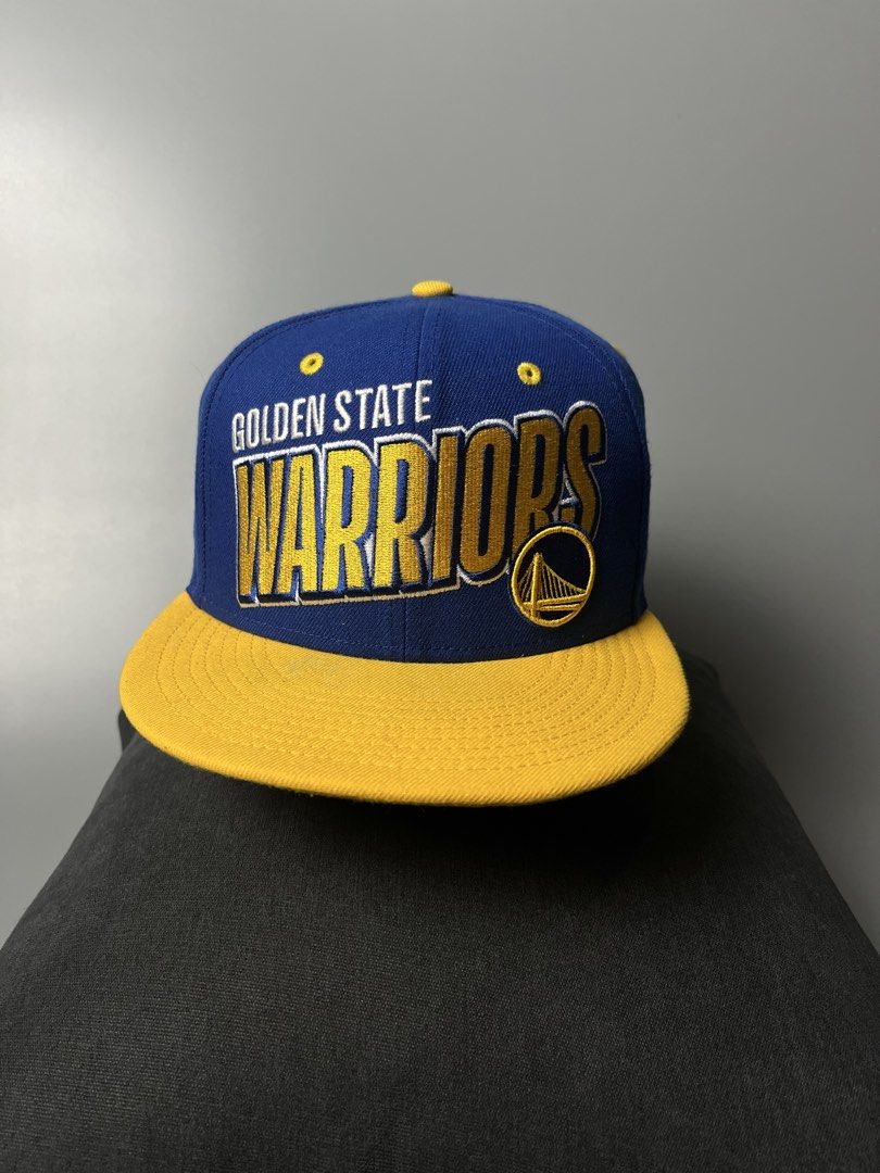New Era Golden State Warriors 9FIFTY Snapback Cap (Category: Caps & Hats) located in Dagupan City. Submitted by loves2thrifth (Listing ID 1470368073, Image 1). Description: - Brand: New Era (Official NBA Merchandise) - Style: 9FIFTY Snapback Cap - Color: Royal blue crown with yellow flat brim and matching strap - Details: Embroidered team branding on front, interior taping and NBA tag intact - Size: Adjustable snap closure fits most - Condition: 