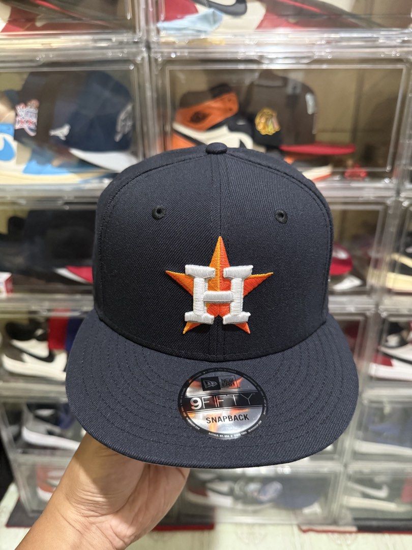 New Era Houston Astros 9FIFTY Snapback Hat (Category: Caps & Hats) located in Manila. Submitted by batoy8814895 (Listing ID 1470433570, Image 1). Description: - Brand: New Era - Team: Houston Astros (9FIFTY snapback model) - Color: Classic dark navy with orange and white embroidered logo - Condition: Brand new, unworn, with original stickers intact - Fit: Adjustable snapback closure for a custom fit - Style: Flat brim with structured crown.