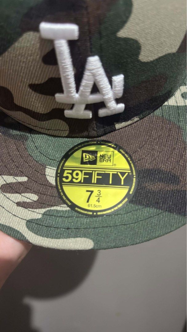 New Era LA Dodgers 59FIFTY Camo Fitted Hat (Category: Caps & Hats) located in Quezon City. Submitted by jizpsa (Listing ID 1470459364, Image 3). Description: - Brand: New Era 59FIFTY - Team: Los Angeles Dodgers (Cooperstown Collection) - Design: All-over woodland camo with raised white LA front embroidery - Size: 7 3/4 (61.5 cm) - Features: Structured crown, flat brim, and original visor sticker intact.