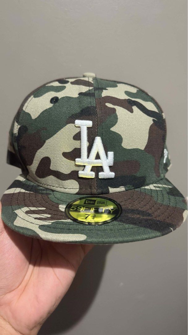 New Era LA Dodgers 59FIFTY Camo Fitted Hat (Category: Caps & Hats) located in Quezon City. Submitted by jizpsa (Listing ID 1470459364, Image 1). Description: - Brand: New Era 59FIFTY - Team: Los Angeles Dodgers (Cooperstown Collection) - Design: All-over woodland camo with raised white LA front embroidery - Size: 7 3/4 (61.5 cm) - Features: Structured crown, flat brim, and original visor sticker intact.