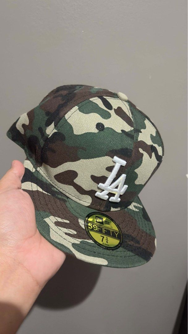 New Era LA Dodgers 59FIFTY Camo Fitted Hat (Category: Caps & Hats) located in Quezon City. Submitted by jizpsa (Listing ID 1470459364, Image 2). Description: - Brand: New Era 59FIFTY - Team: Los Angeles Dodgers (Cooperstown Collection) - Design: All-over woodland camo with raised white LA front embroidery - Size: 7 3/4 (61.5 cm) - Features: Structured crown, flat brim, and original visor sticker intact.