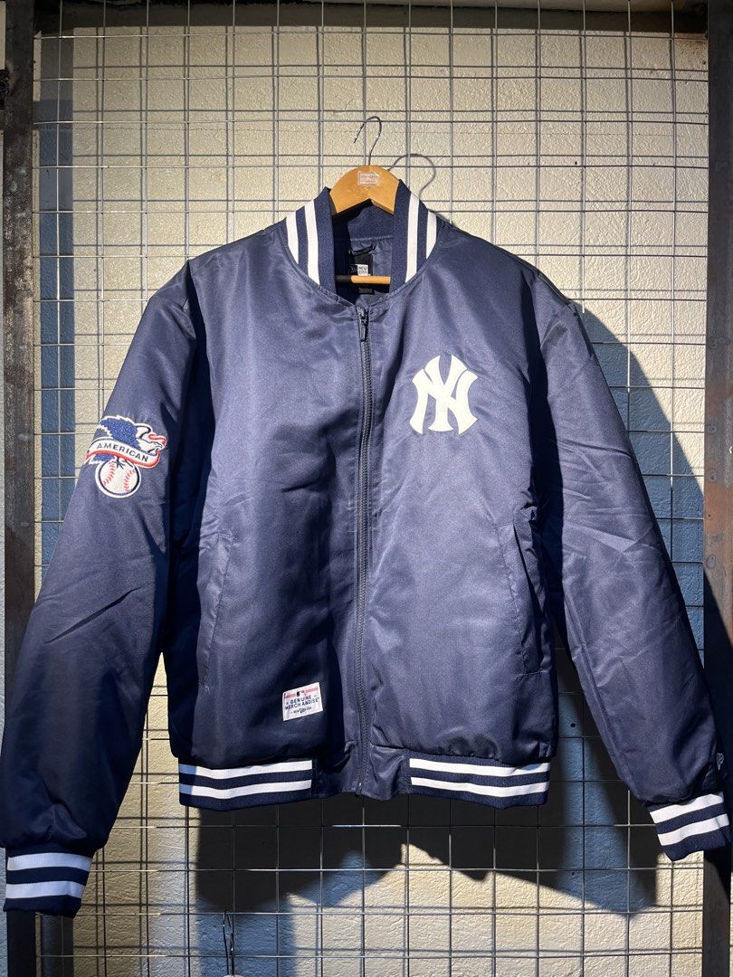 New Era New York Yankees Bomber Jacket (Category: Coats, Jackets and Outerwear) located in Manila. Submitted by roballenad66487 (Listing ID 1470386400, Image 1). Description: - Brand: New Era - Style: Bomber Jacket (Full Zip) - Color: Navy Blue - Team: New York Yankees (Chest embroidery & big back 'NEW YORK' lettering) - Details: American League patch on right sleeve, quilted inner lining, striped rib-knit collar, cuffs, and hem - Condition: Bran