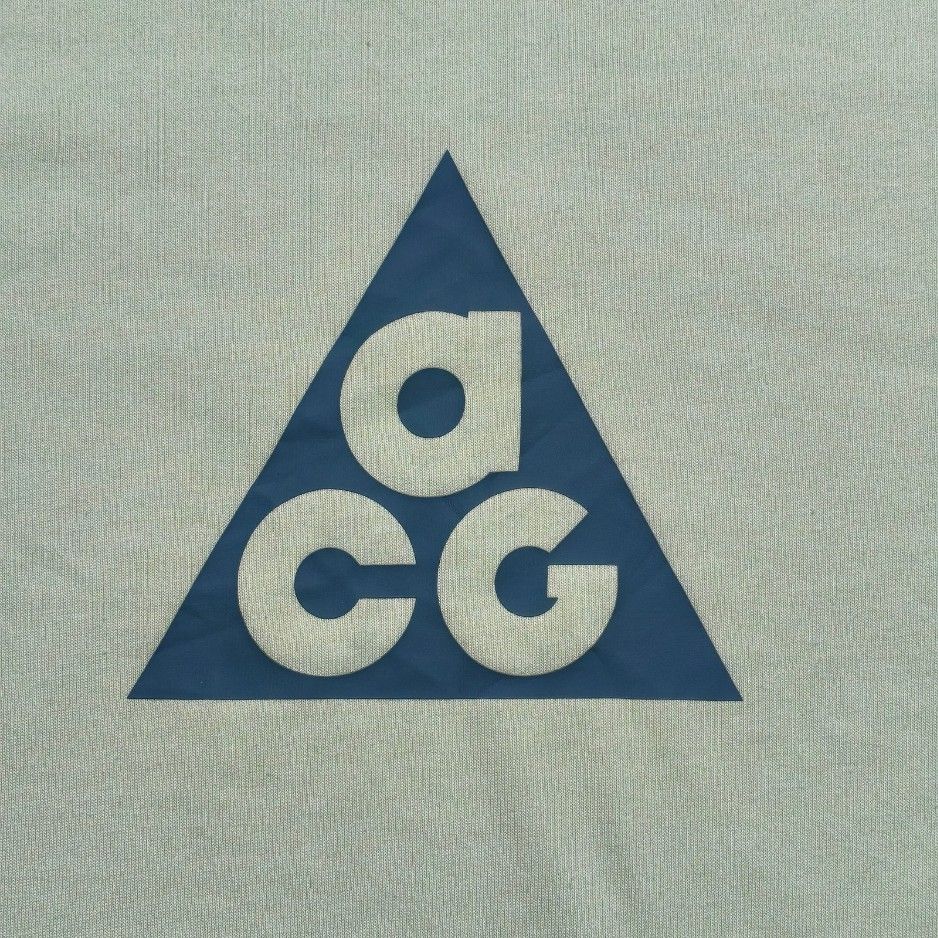 Nike ACG Green Triangle Logo T-Shirt (Category: Tshirts & Polo Shirts ) located in Meycauayan. Submitted by thrifting_gorilla (Listing ID 1470412263, Image 3). Description: Nike ACG Green Triangle Logo T-Shirt - Brand: Nike ACG - Color: Pale green with dark teal chest logo - Style: Casual everyday streetwear, standard short sleeve - Material: Lightweight cotton feel - Condition: Well-kept, clean shape and collar tag.