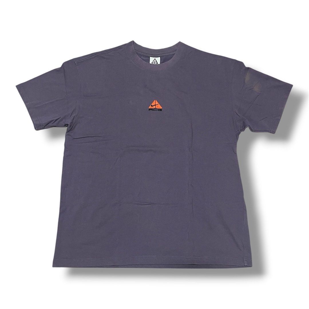 Nike ACG Lungs Tee (Category: Tshirts & Polo Shirts ) located in Manila. Submitted by jstash09 (Listing ID 1470491660, Image 1). Description: - Brand/Model: Nike ACG - Color: Dark grey - Details: Small embroidered orange triangle logo on the chest - Fit: Relaxed fit with short sleeves - Condition/Feature: Clean collar tag, great casual streetwear staple - Styling: Easy to pair with cargo pants or denim - 22 x 28.