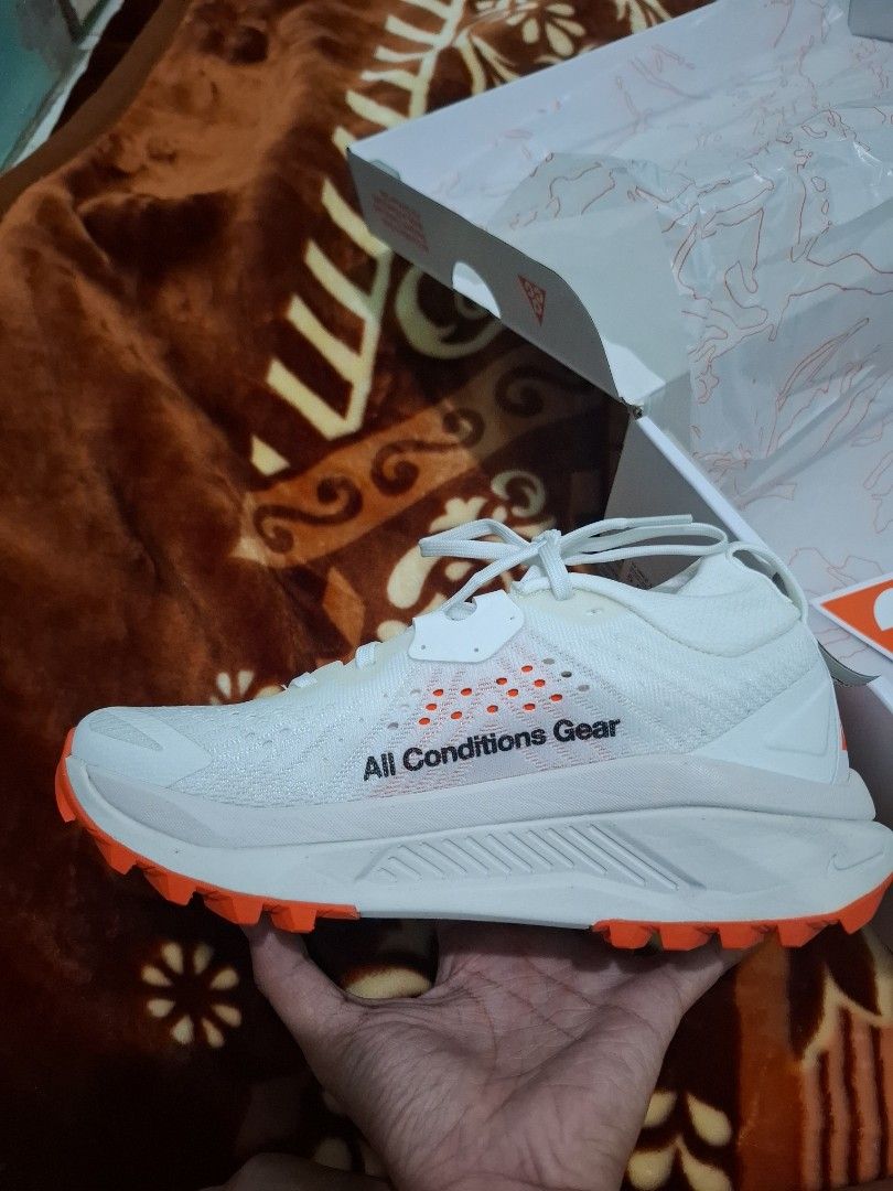 Nike ACG Mountain Fly 2 Low White Orange (Category: Hiking & Camping) located in Vinzons. Submitted by miaebona672 (Listing ID 1470469707, Image 2). Description: - Brand new, unworn condition with original Nike ACG box - Colorway: White and Bright Orange - ZoomX foam midsole for ultimate - Size 5.5Y cushioning - Rugged Vibram outsole for maximum traction and grip - Iconic All Conditions Gear branding on side and heel - Ideal for outdoor treks, hi