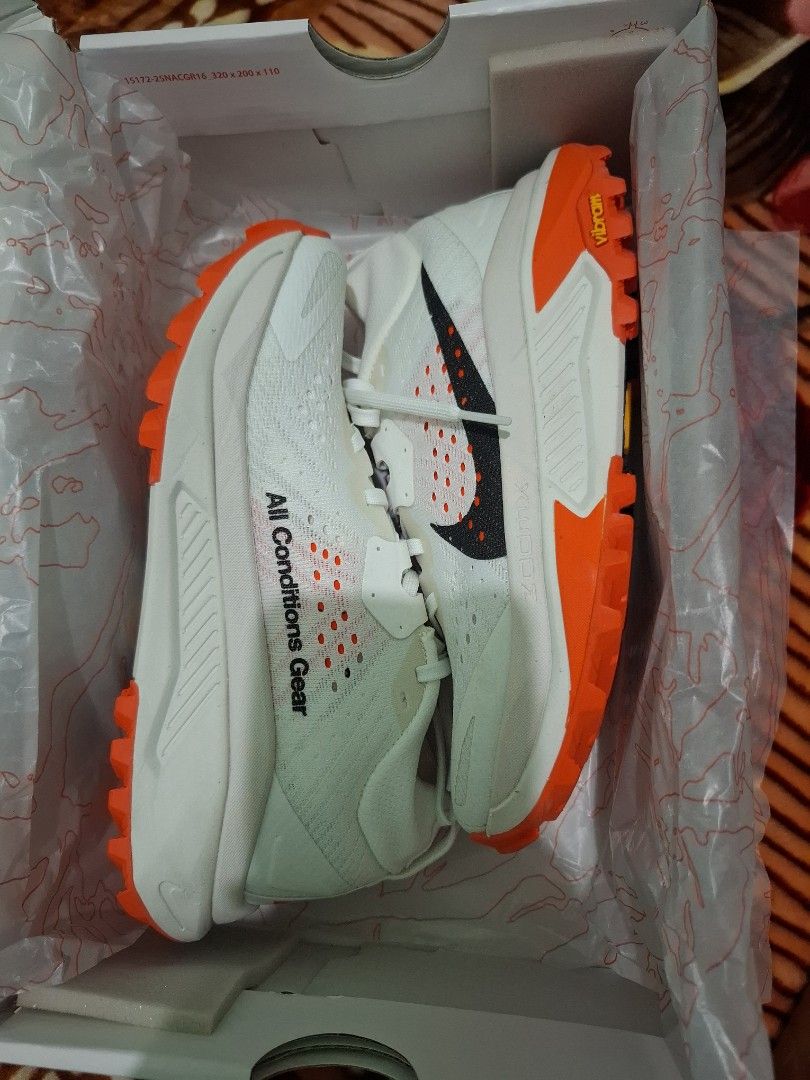 Nike ACG Mountain Fly 2 Low White Orange (Category: Hiking & Camping) located in Vinzons. Submitted by miaebona672 (Listing ID 1470469707, Image 1). Description: - Brand new, unworn condition with original Nike ACG box - Colorway: White and Bright Orange - ZoomX foam midsole for ultimate - Size 5.5Y cushioning - Rugged Vibram outsole for maximum traction and grip - Iconic All Conditions Gear branding on side and heel - Ideal for outdoor treks, hi