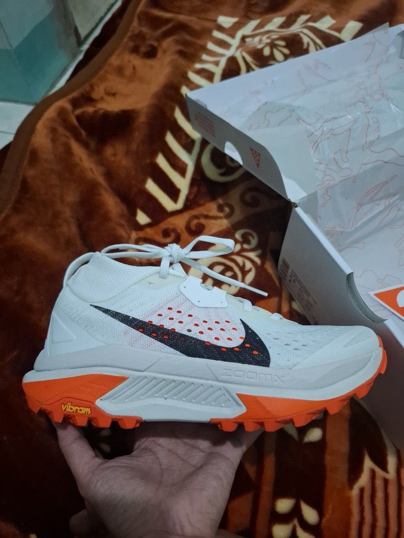 Nike ACG Mountain Fly 2 Low White Orange (Category: Hiking & Camping) located in Vinzons. Submitted by miaebona672 (Listing ID 1470469707, Image 3). Description: - Brand new, unworn condition with original Nike ACG box - Colorway: White and Bright Orange - ZoomX foam midsole for ultimate - Size 5.5Y cushioning - Rugged Vibram outsole for maximum traction and grip - Iconic All Conditions Gear branding on side and heel - Ideal for outdoor treks, hi