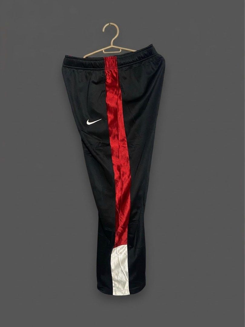 Nike Black and Red Track Pants Size L (Category: Joggers) located in Bangued. Submitted by koroysthrifts (Listing ID 1470495565, Image 1). Description: - Brand: Nike 28-32x35.5x9 - Color: Black with red side stripes - Logo: White logo hit on the hip - Size: Large - Condition: Clean, ready to wear - Features: Elastic waist for comfort, made in China - Ideal for: Workouts or lounging.