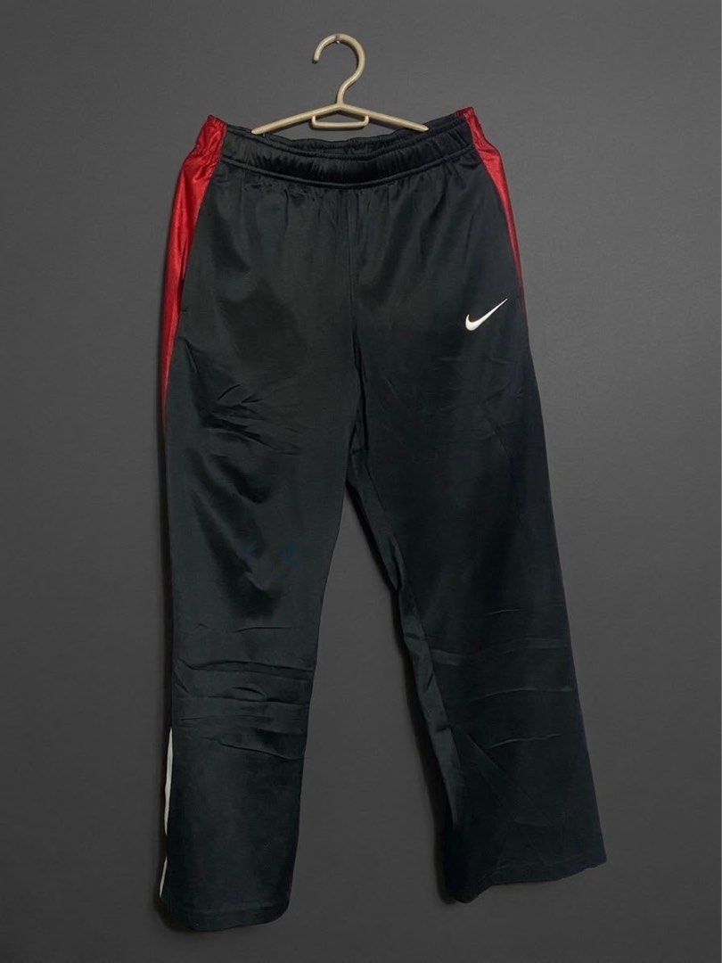 Nike Black and Red Track Pants Size L (Category: Joggers) located in Bangued. Submitted by koroysthrifts (Listing ID 1470495565, Image 2). Description: - Brand: Nike 28-32x35.5x9 - Color: Black with red side stripes - Logo: White logo hit on the hip - Size: Large - Condition: Clean, ready to wear - Features: Elastic waist for comfort, made in China - Ideal for: Workouts or lounging.