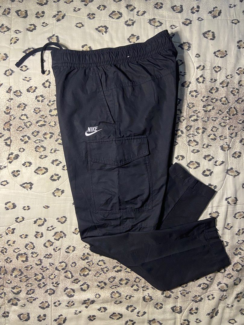 Nike Black Cargo Pants Size Small (Category: Joggers) located in Manila. Submitted by nix.thrift (Listing ID 1470410333, Image 1). Description: - Brand: Nike - Color: Solid Black - Size: Small (S) - Condition: Clean fabric, great staple piece - Features: Elastic waistband with adjustable drawstring, multiple side and back cargo pockets - Details: Embroidered Nike logo on the right pocket and woven label near the waist - Origin: Made in Vietnam - 