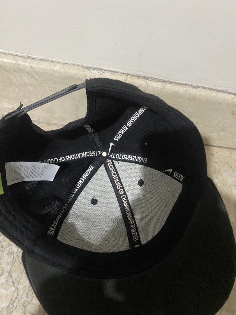 Nike Black Flat Brim Cap with Raised Letters (Category: Caps & Hats) located in Manila. Submitted by primomirp (Listing ID 1470458054, Image 3). Description: - Brand: Nike - Style: Flat brim snapback cap - Color: Black with large raised block letters wrapping around - Details: Interior taped seams with 'Engineered to the exact specifications of championship athletes' - Closure: Adjustable snapback - Condition: Clean inside and out, minimal wear.