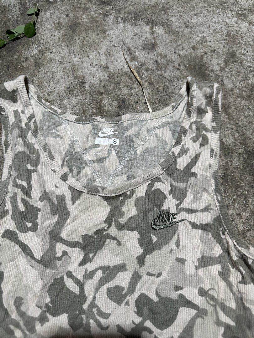 Nike Camo Ribbed Tank Top Size S (Category: Sleeveless) located in General Santos City (Dadiangas). Submitted by darylvoid (Listing ID 1470393682, Image 2). Description: - Brand: Nike - Style: Ribbed tank top with scoop neck - Print/Color: Beige and green camo - Details: Embroidered Nike swoosh logo on chest - Size: Small (S) - Material: 100% soft, breathable cotton - Origin: Made in Sri Lanka - Condition: Excellent.