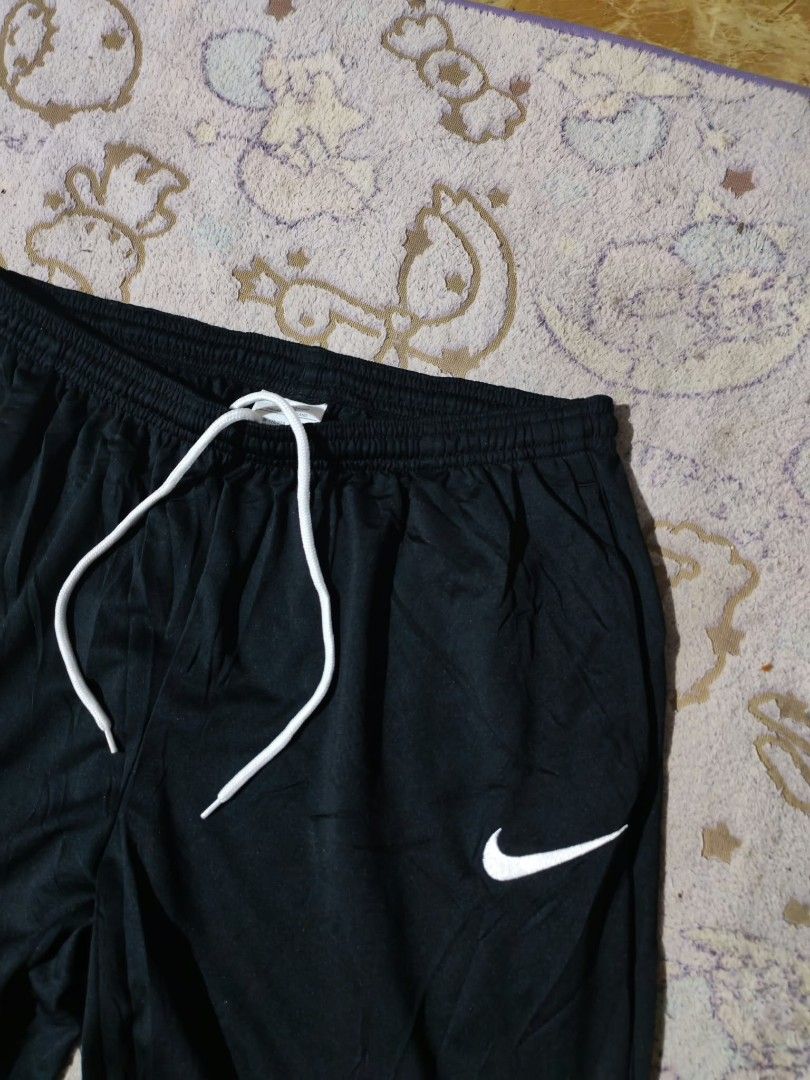 Nike Dri-FIT Black Sweatpants Size L (Category: Joggers) located in Sipalay. Submitted by boldowl.e4f283 (Listing ID 1470488019, Image 3). Description: - Brand: Nike - Item: Dri-FIT Training Pants - Color: Solid Black - Size: L (Tag printed inside) - Origin: Made in Thailand - Features: White drawstring waist, classic swoosh logo on left leg, lightweight fabric, and comfortable elastic waistband - Condition/Use: Great for workouts or daily casual