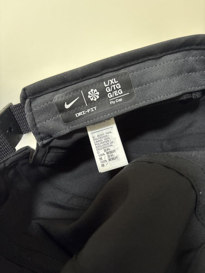 Nike Dri-FIT Fly Cap Black L/XL (Category: Caps & Hats) located in Brookes Point. Submitted by tntkicks (Listing ID 1470360088, Image 3). Description: - Brand: Nike - Model: Dri-FIT Fly Cap - Color: Black - Size: L/XL - Material: Lightweight, breathable polyester with Dri-FIT moisture-wicking technology - Design: White embroidered Swoosh on the front panel - Closure: Adjustable strapback with a debossed Nike Swoosh metal buckle - Condition: Clean