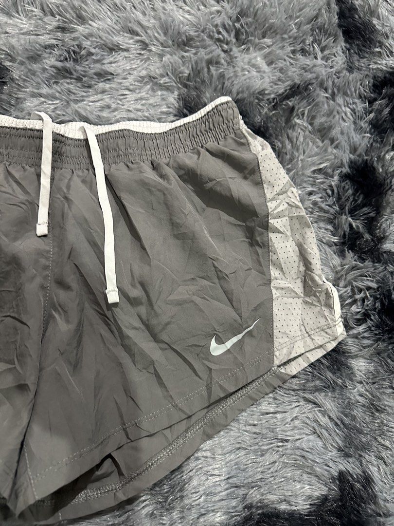 Nike Dri-Fit Grey Running Shorts Size S (Category: Activewear) located in Iba. Submitted by thriftcoyan (Listing ID 1470491243, Image 2). Description: - Brand: Nike -Size 28-31 -Length 9.5 - Item: Running Shorts - Size: Small - Color: Grey with white drawstring - Material: Lightweight Dri-Fit (breathable mesh side panels) - Origin: Made in Vietnam - Features: Classic swoosh logo near hem, quick-dry technology for workouts.