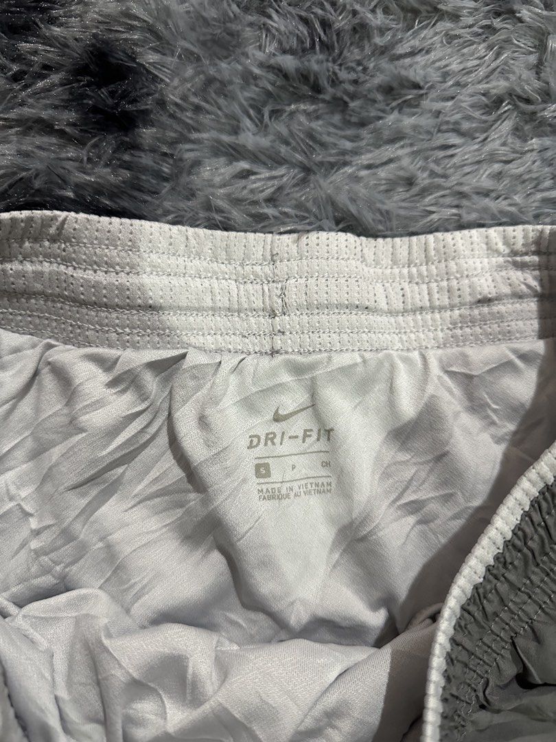 Nike Dri-Fit Grey Running Shorts Size S (Category: Activewear) located in Iba. Submitted by thriftcoyan (Listing ID 1470491243, Image 3). Description: - Brand: Nike -Size 28-31 -Length 9.5 - Item: Running Shorts - Size: Small - Color: Grey with white drawstring - Material: Lightweight Dri-Fit (breathable mesh side panels) - Origin: Made in Vietnam - Features: Classic swoosh logo near hem, quick-dry technology for workouts.