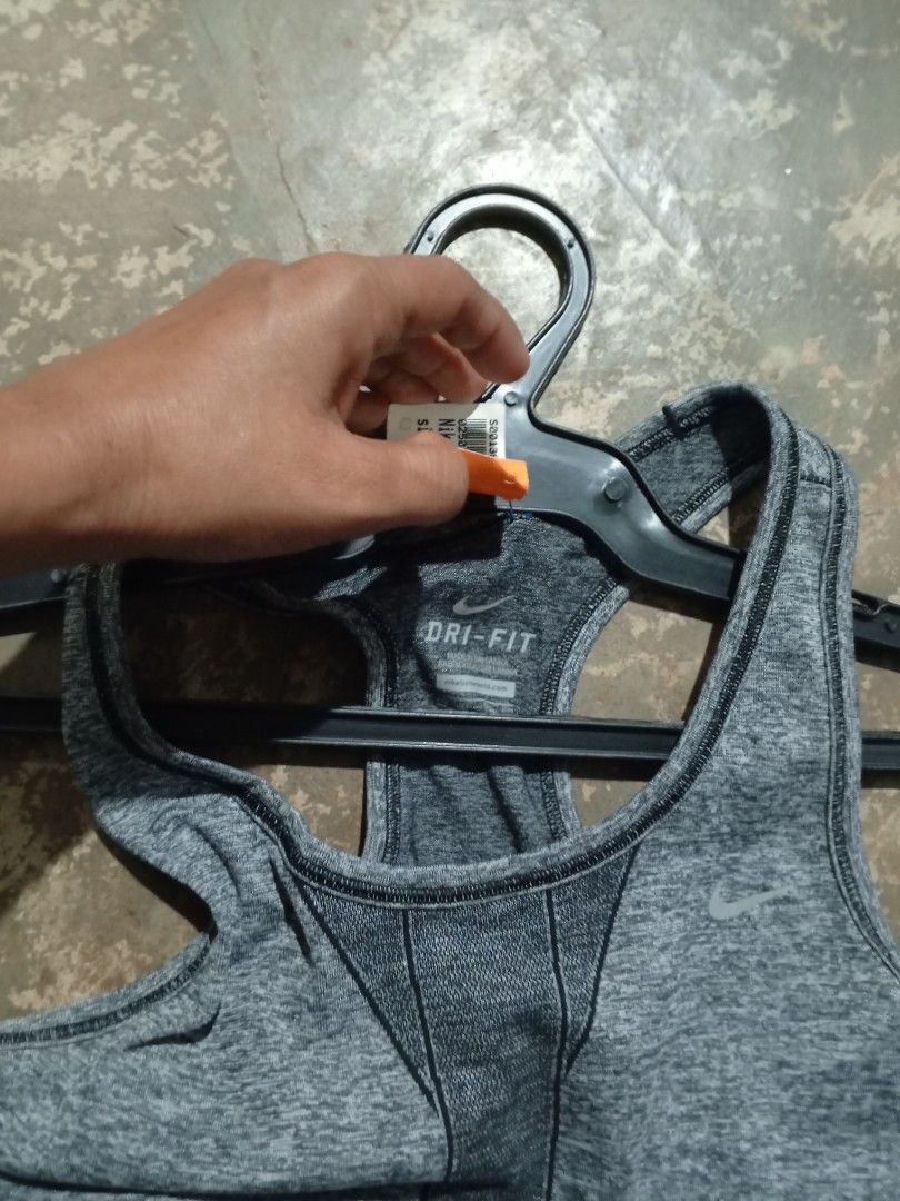 Nike Dri-FIT Grey Running Tank Top (Category: Activewear) located in Binmaley. Submitted by ezekislacl02490 (Listing ID 1470552257, Image 3). Description: - Brand new with original store tag attached - Size: Women's S - Color: Heather grey with contrast dark grey racerback paneling - Material: Lightweight and breathable Dri-FIT fabric - Feature: Ventilation text print near the hem - Ideal for running and gym workouts.