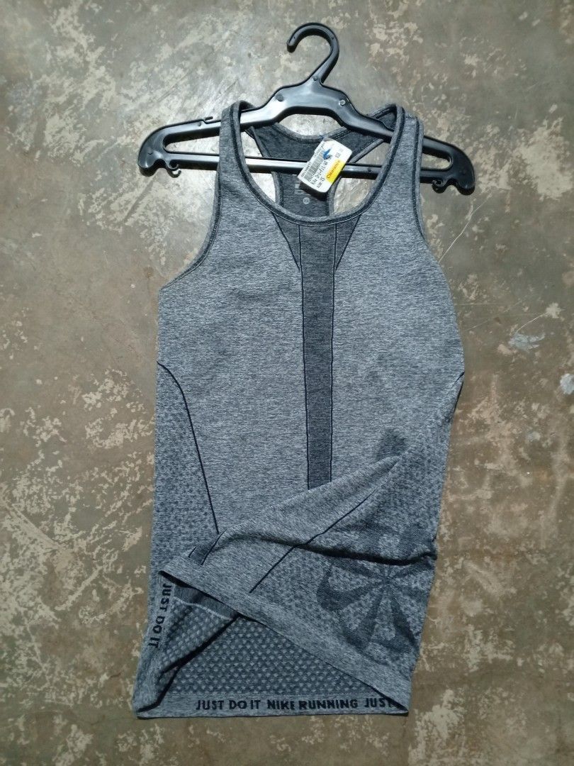 Nike Dri-FIT Grey Running Tank Top (Category: Activewear) located in Binmaley. Submitted by ezekislacl02490 (Listing ID 1470552257, Image 1). Description: - Brand new with original store tag attached - Size: Women's S - Color: Heather grey with contrast dark grey racerback paneling - Material: Lightweight and breathable Dri-FIT fabric - Feature: Ventilation text print near the hem - Ideal for running and gym workouts.