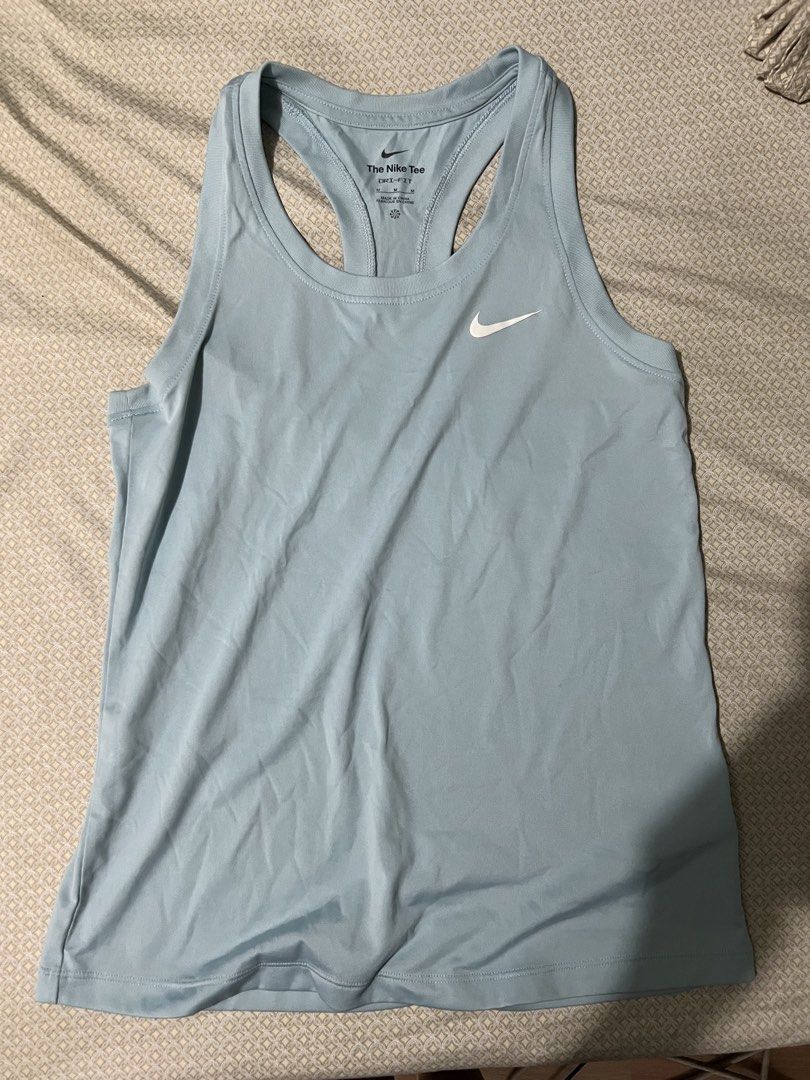 Nike Dri-Fit Light Blue Tank Top Size M (Category: Activewear) located in Marikina City. Submitted by tintinarenas (Listing ID 1470464376, Image 1). Description: - Brand: Nike - Item: Dri-Fit Racerback Tank Top - Color: Light blue with white printed swoosh - Size: Medium (The Nike Tee tag) - Material: Smooth, lightweight fabric ideal for running and workouts.