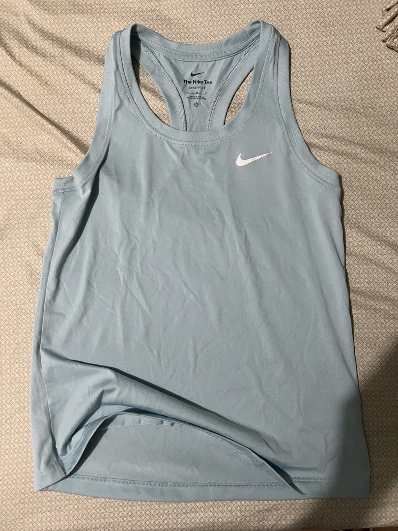 Nike Dri-Fit Light Blue Tank Top Size M (Category: Activewear) located in Marikina City. Submitted by tintinarenas (Listing ID 1470464376, Image 2). Description: - Brand: Nike - Item: Dri-Fit Racerback Tank Top - Color: Light blue with white printed swoosh - Size: Medium (The Nike Tee tag) - Material: Smooth, lightweight fabric ideal for running and workouts.