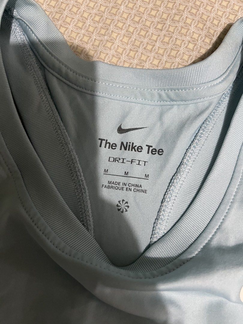 Nike Dri-Fit Light Blue Tank Top Size M (Category: Activewear) located in Marikina City. Submitted by tintinarenas (Listing ID 1470464376, Image 3). Description: - Brand: Nike - Item: Dri-Fit Racerback Tank Top - Color: Light blue with white printed swoosh - Size: Medium (The Nike Tee tag) - Material: Smooth, lightweight fabric ideal for running and workouts.